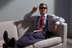 Bruce Wayne as Batman relaxing on a couch in a striped shirt and sunglasses, Patrick Bateman's Rolex Datejust heralded the new 'executive style'. British GQ HD wallpaper