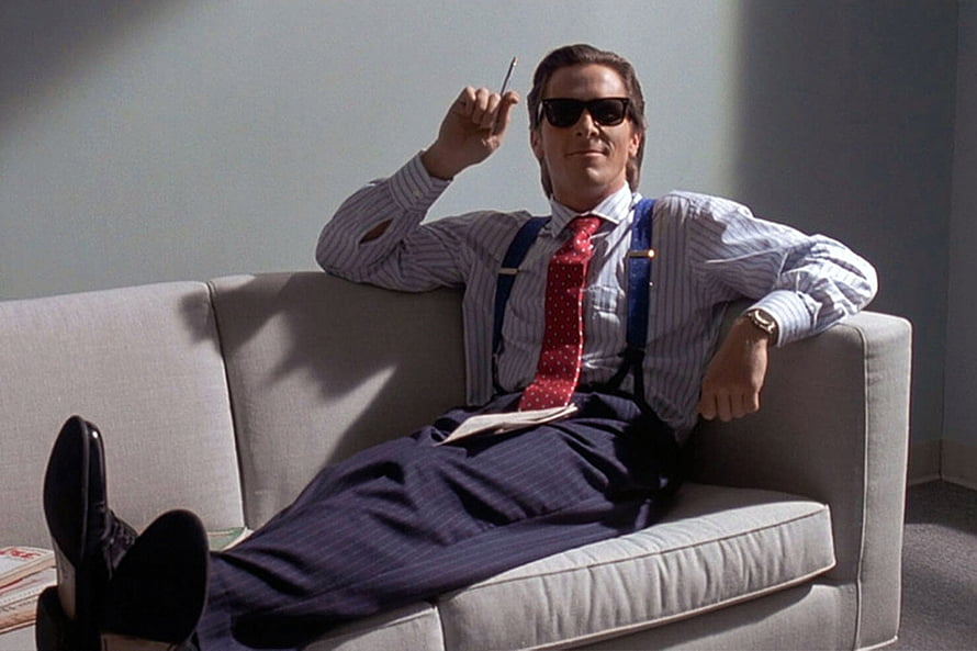 Bruce Wayne as Batman relaxing on a couch in a striped shirt and sunglasses, Patrick Bateman's Rolex Datejust heralded the new 'executive style'. British GQ HD wallpaper