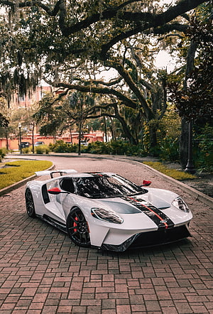 White Ford GT Supercar with Black and Red Stripes Parked on Brick Road HD phone wallpaper
