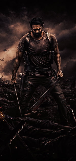 Intense warrior standing on a battlefield with dual swords amidst smoke and helicopters HD phone wallpaper