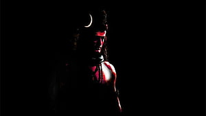 Lord Shiva Mahadev with Crescent Moon and Rudraksha Beads in Dramatic Shadow HD wallpaper