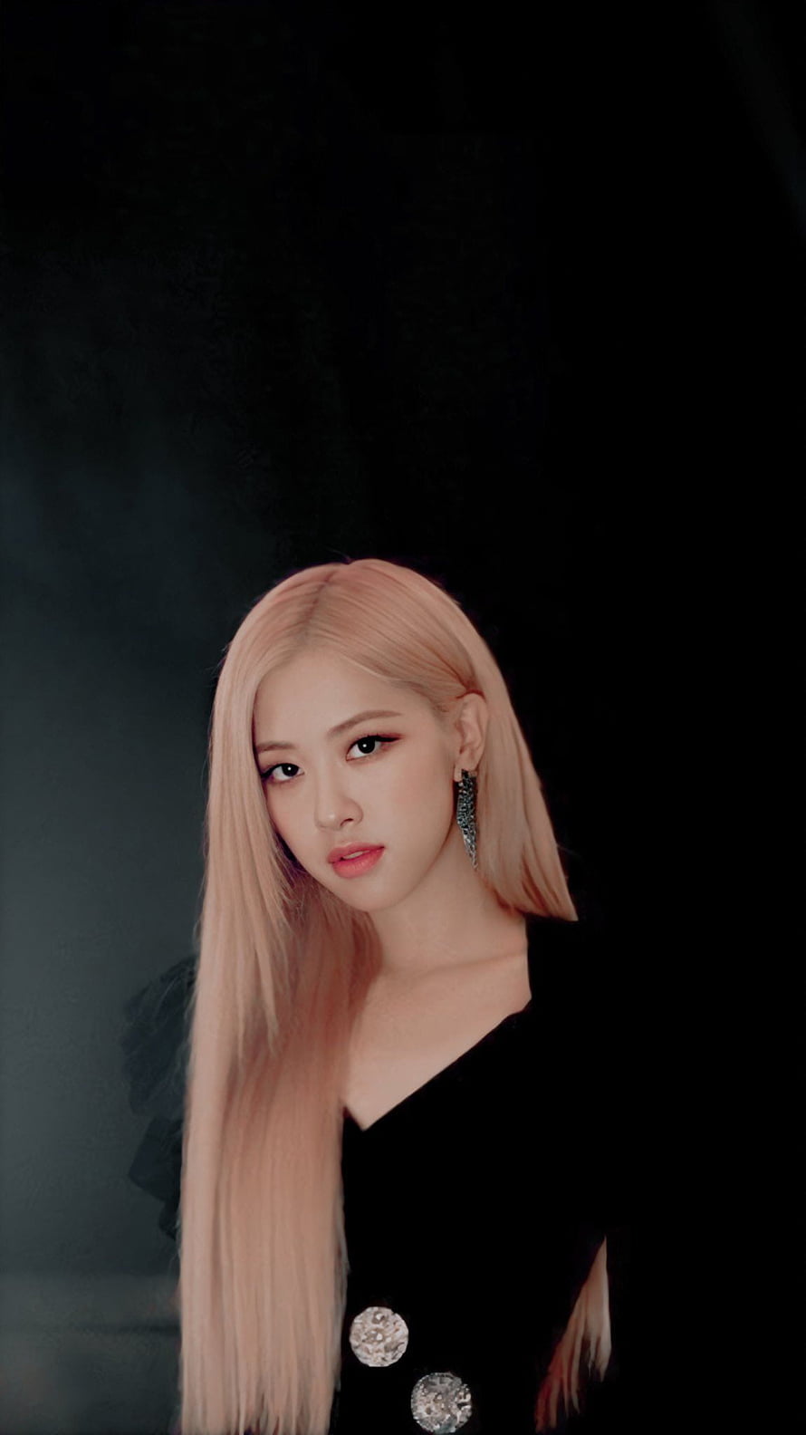 Rosé from Blackpink with long pink hair wearing a black dress and sparkling earrings against a dark background HD phone wallpaper