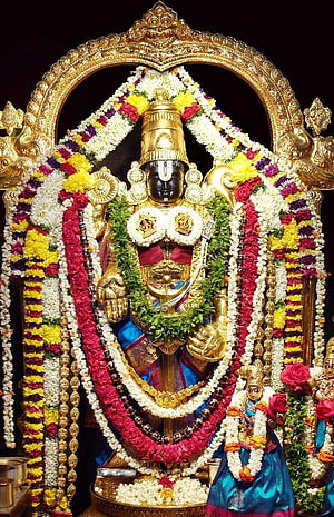 Ornate Hindu Deity Statue Adorned with Colorful Flower Garlands and Golden Crown HD phone wallpaper