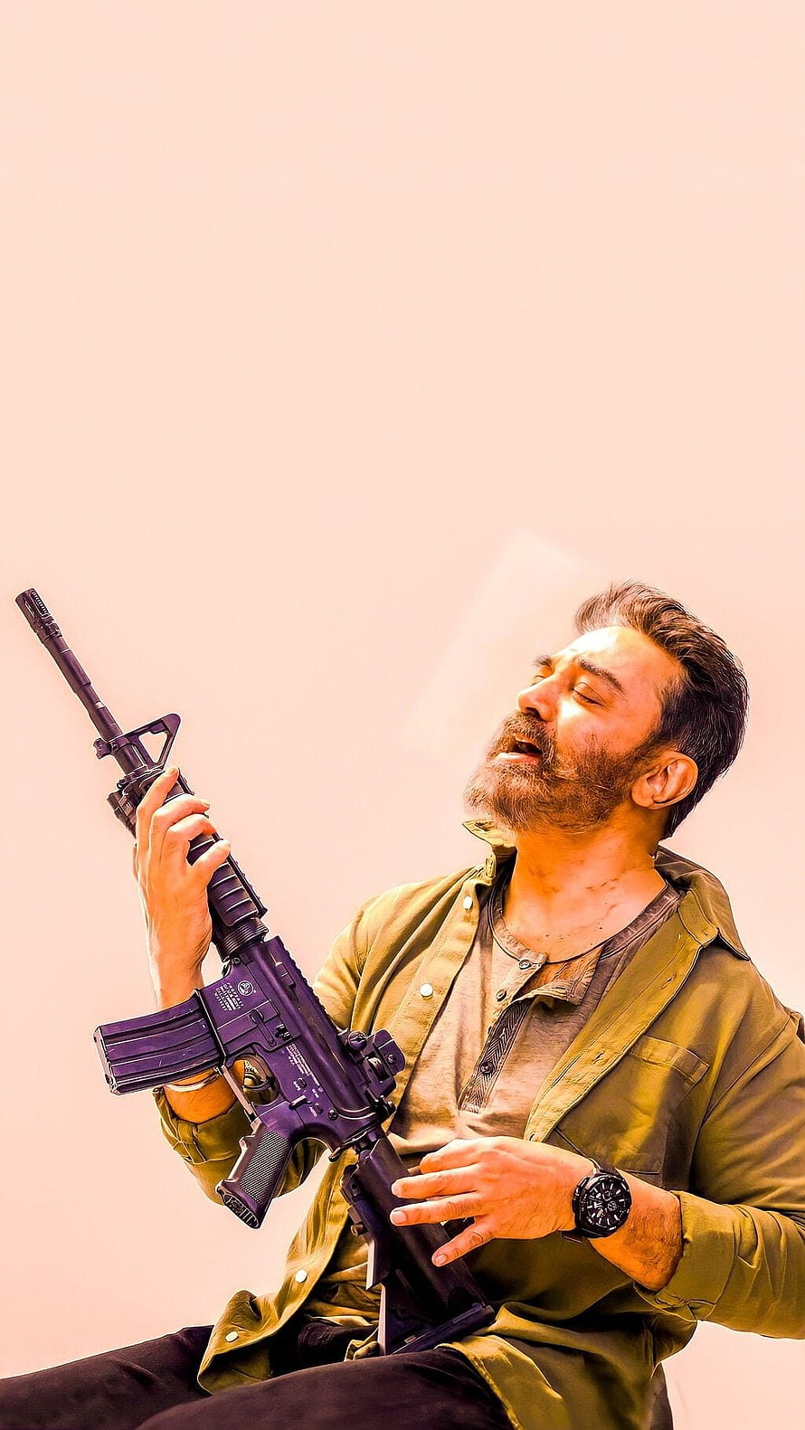 Man with beard holding purple rifle in green shirt against pink background, Kamal Hassan, vikram, tamil movie HD phone wallpaper