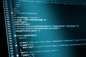 Close-up of computer programming code on a monitor screen with blue background HD wallpaper
