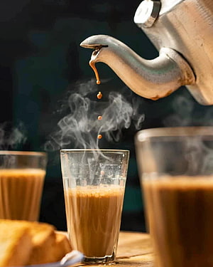 Hot Tea Pouring From Vintage Metal Teapot Into Glass Cup With Steam HD phone wallpaper