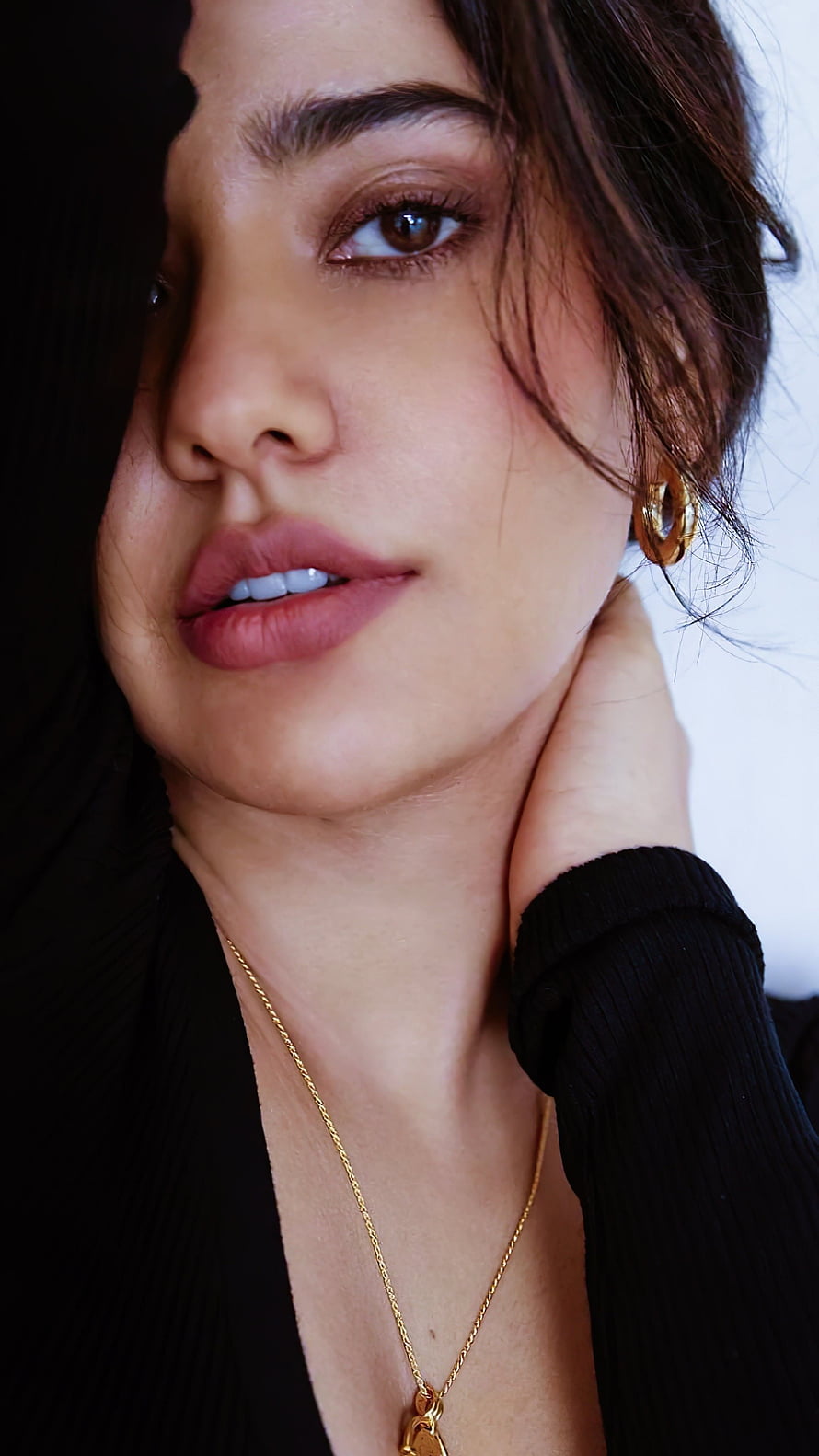 Close-up portrait of a woman with brown eyes wearing gold jewelry and a black top, Neha sharma, bollywood actress HD phone wallpaper