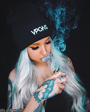 Platinum Blonde Woman with Intricate Hand Tattoos Vaping Blue Smoke Against Black Background, woman #tattoos #girl #smoking #smoke #toedit #landscape - Vape Girl -, Women Smoke HD phone wallpaper