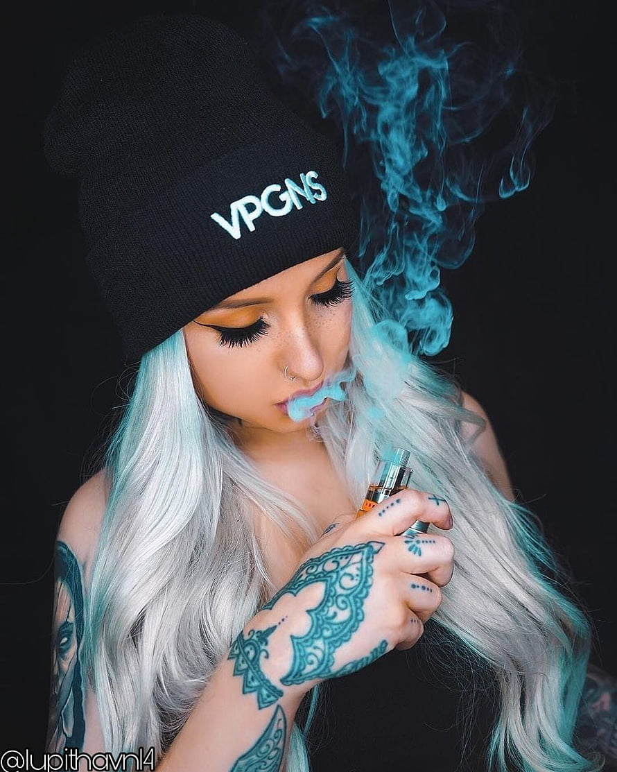 Platinum Blonde Woman with Intricate Hand Tattoos Vaping Blue Smoke Against Black Background, woman #tattoos #girl #smoking #smoke #toedit #landscape - Vape Girl -, Women Smoke HD phone wallpaper