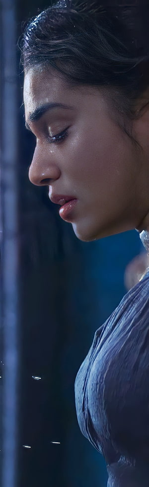 Disha Patani in a dramatic close-up with wet hair and skin, wearing a soaked blue outfit against a dark background HD phone wallpaper