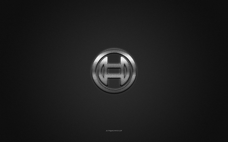Sleek Metallic H Emblem on Dark Carbon Fiber Background HD wallpaper
