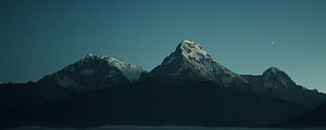 Snow-Capped Mountain Peaks Under a Starry Night Sky HD wallpaper