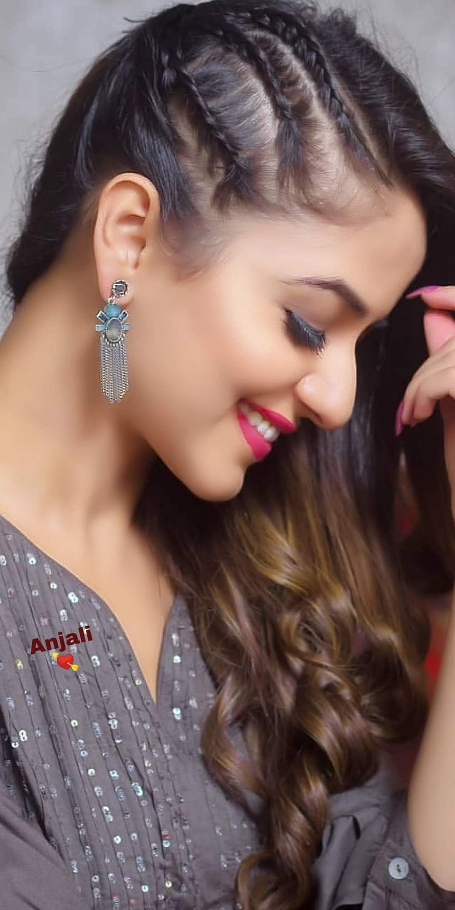 Anjali with braided hairstyle and long earrings smiling portrait HD phone wallpaper