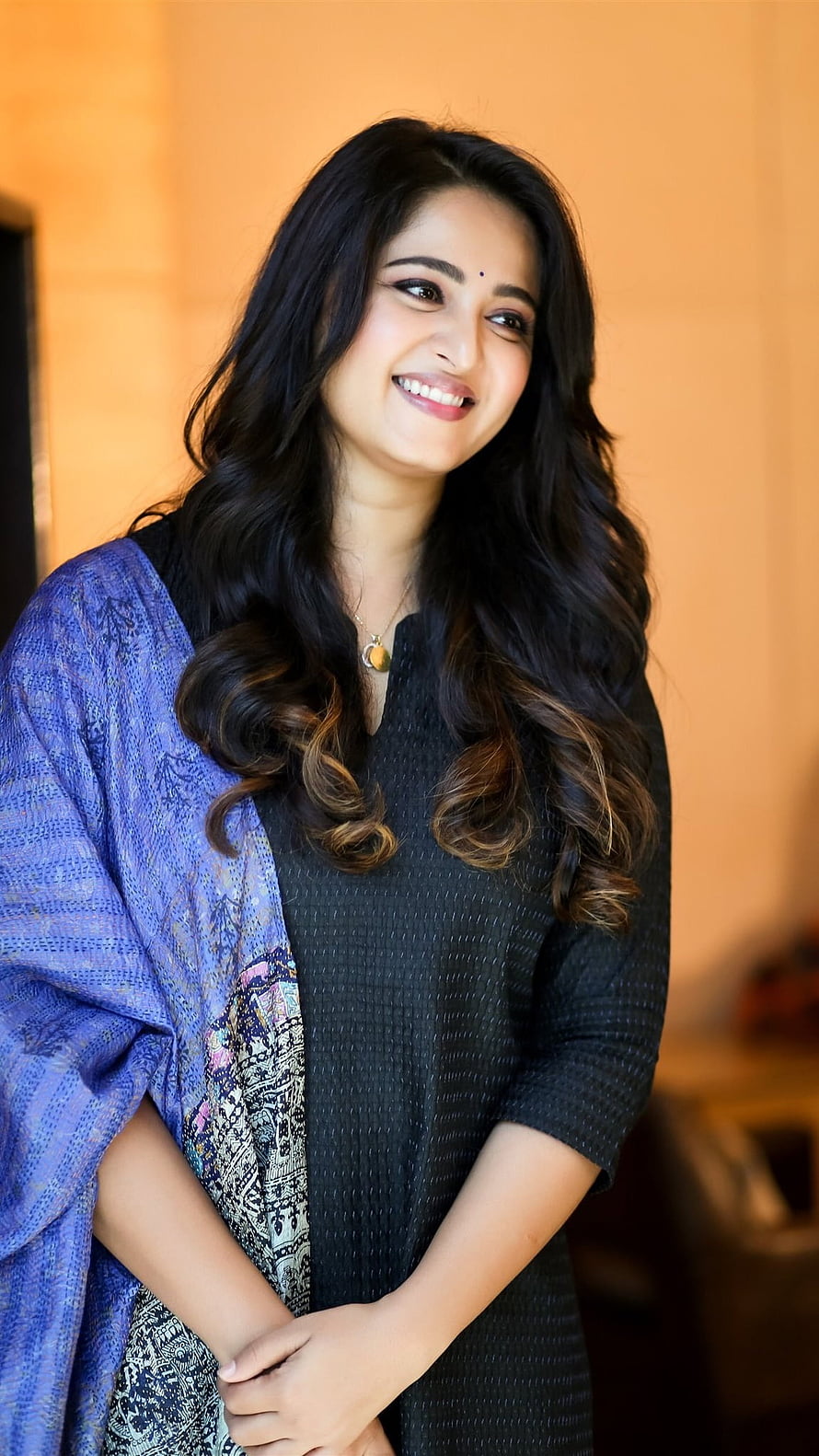 Anushka Shetty smiling portrait wearing a black kurta with a blue patterned dupatta draped over her shoulder HD phone wallpaper