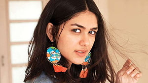 Portrait of a woman with long dark hair wearing colorful patterned tassel earrings, Mrunal Thakur HD wallpaper