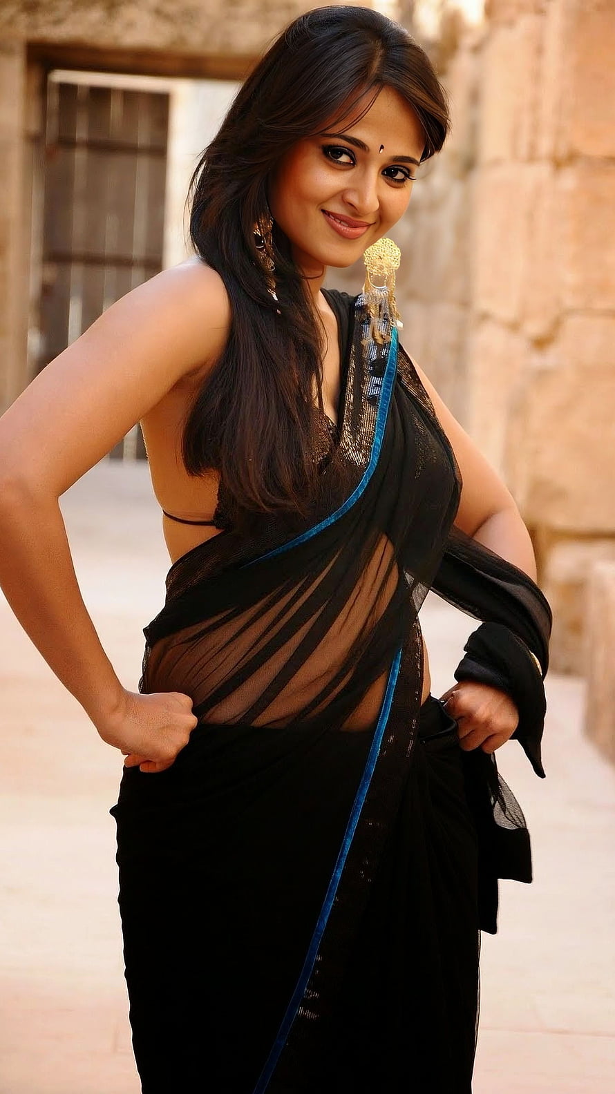 Anushka Shetty in a Black Sheer Saree with Blue Border and Traditional Jewelry HD phone wallpaper
