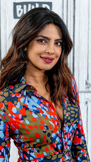 Priyanka Chopra in a colorful abstract patterned blouse with long wavy hair HD phone wallpaper
