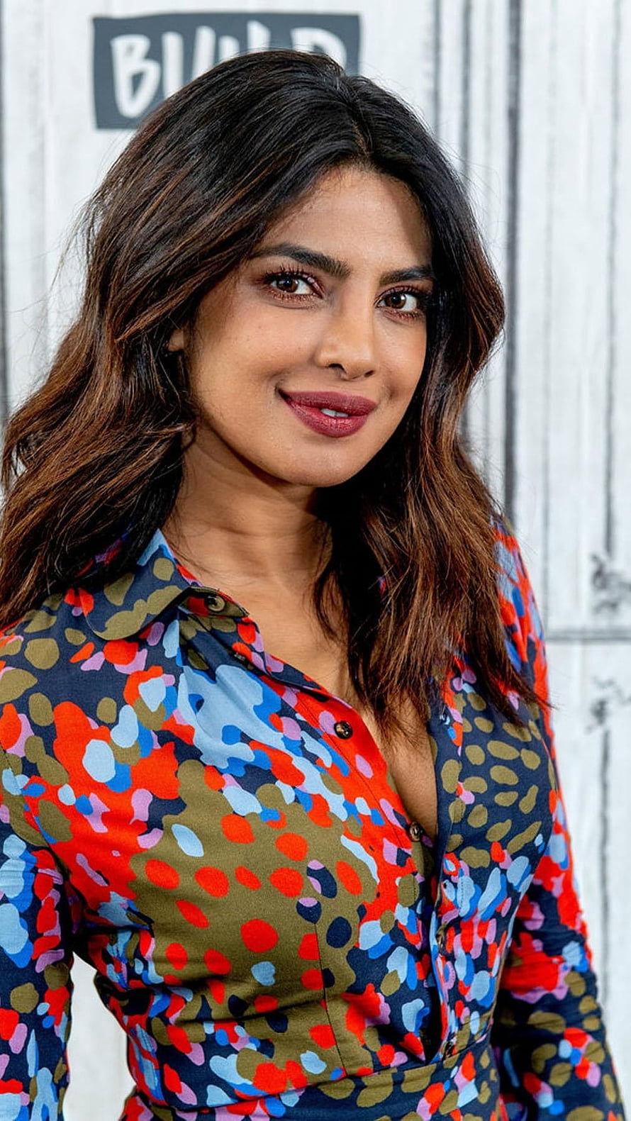 Priyanka Chopra in a colorful abstract patterned blouse with long wavy hair HD phone wallpaper