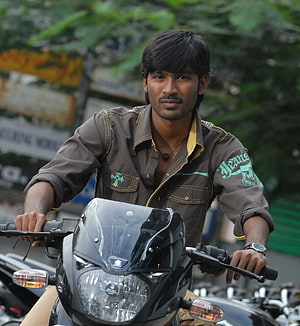Dhanush on a Suzuki Motorcycle in Urban Street Setting HD phone wallpaper