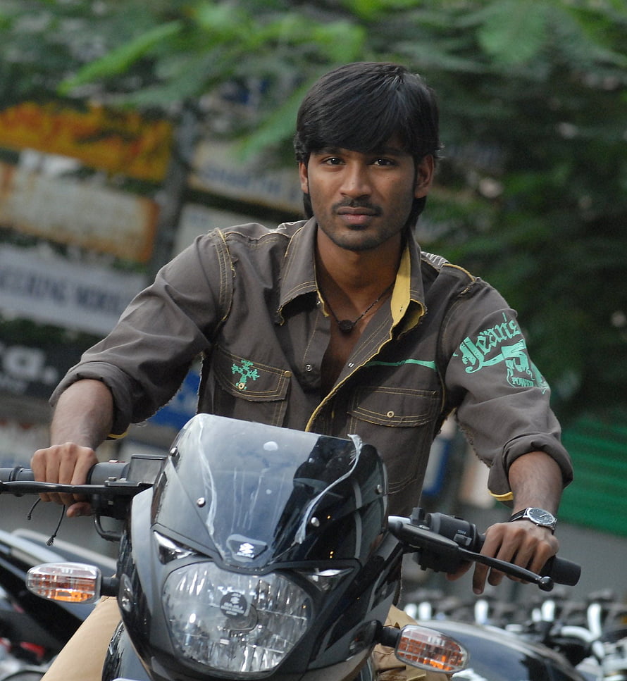 Dhanush on a Suzuki Motorcycle in Urban Street Setting HD phone wallpaper