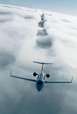 Private Jet Cruising Above a Thick Layer of White Clouds in a Serene Sky HD phone wallpaper