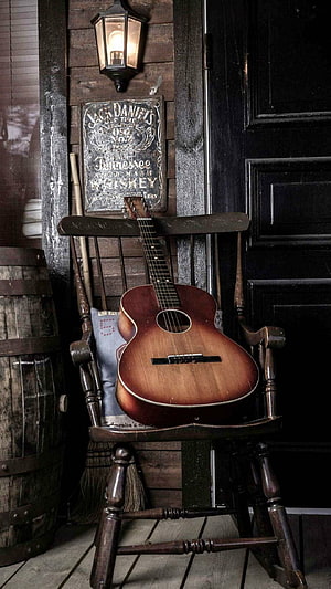 Vintage Martin Acoustic Guitar Resting on a Rustic Wooden Rocking Chair HD phone wallpaper