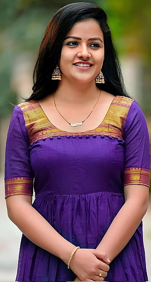 Vaishnavi Chaitanya in a purple traditional dress with gold jewelry and a warm smile HD phone wallpaper