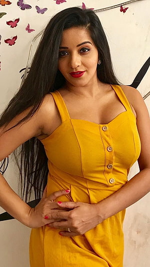 Antara Biswas in a Vibrant Yellow Button-Down Dress with Butterfly Wall Decor HD phone wallpaper