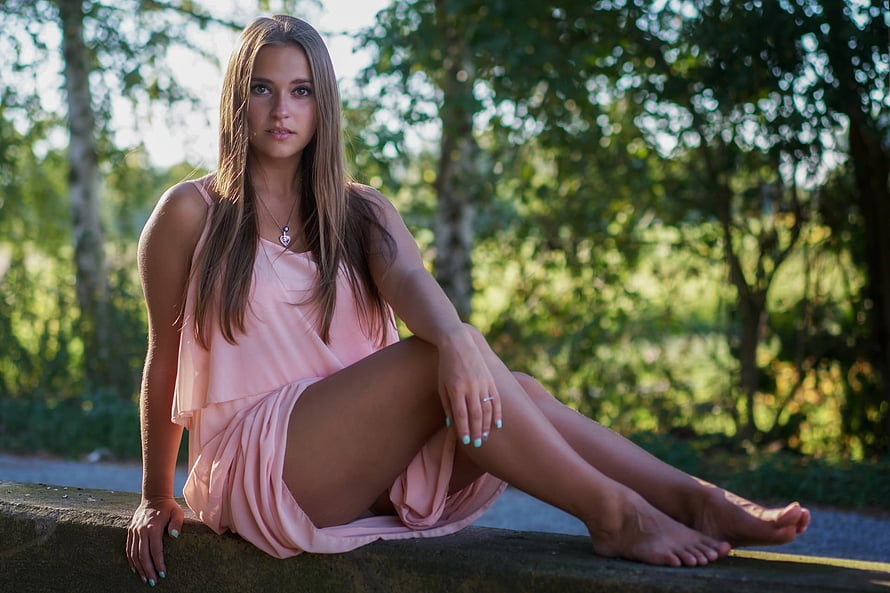 Young Woman in Pink Dress Sitting on Stone Wall in Sunlit Forest, Brunette, Girl, Beautiful, Beauty, Woman, Model, Lovely, Female HD wallpaper