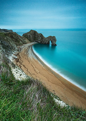 Porthcressi Beach Natural Rock Arch and Turquoise Waters in Wales HD phone wallpaper