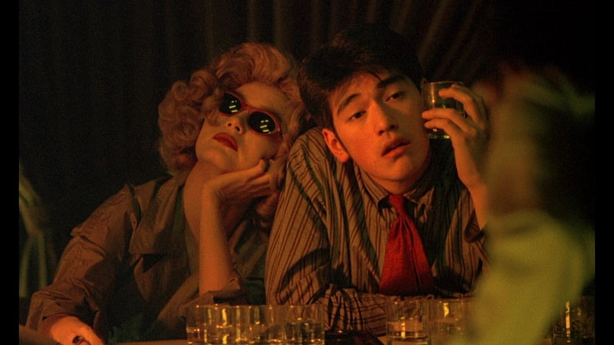 Chungking Express cinematic still of two characters in a dimly lit bar with warm amber lighting HD wallpaper