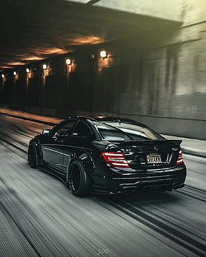 Black Mercedes C63 AMG Stance Build Cruising Through a Dimly Lit Tunnel HD phone wallpaper