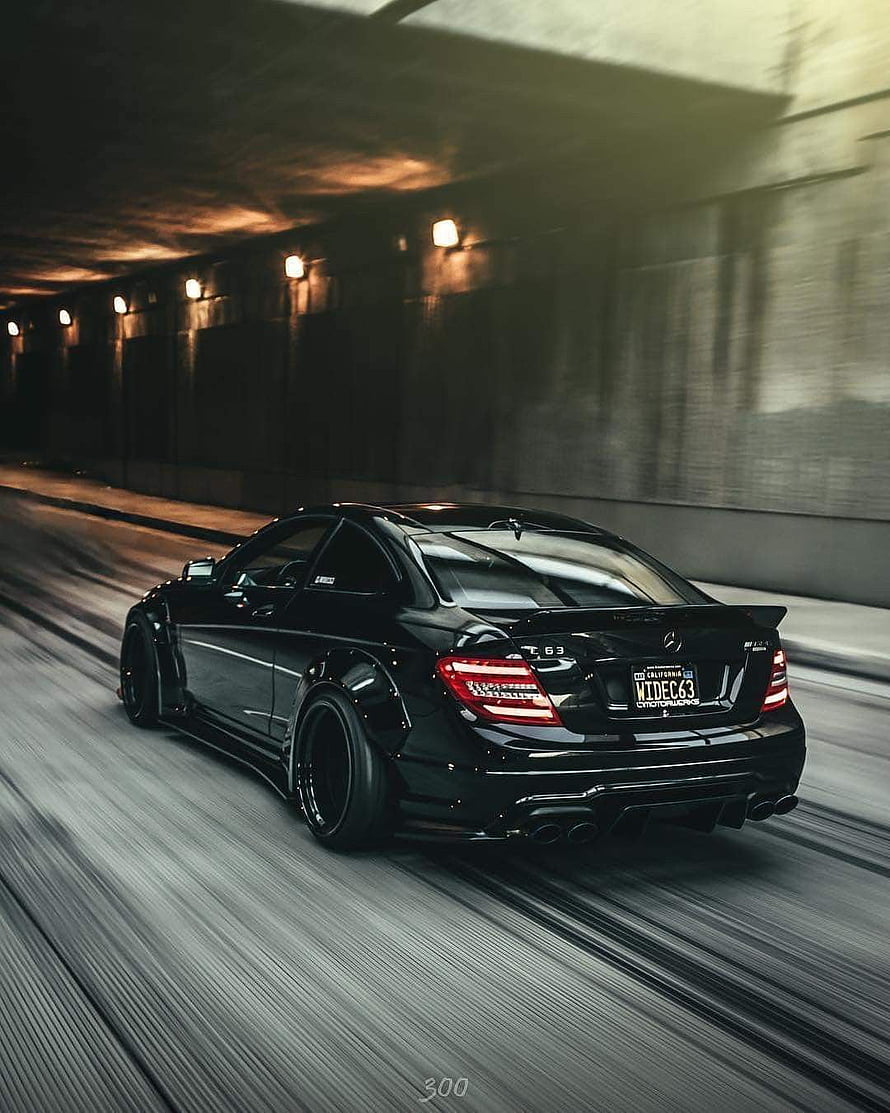 Black Mercedes C63 AMG Stance Build Cruising Through a Dimly Lit Tunnel HD phone wallpaper