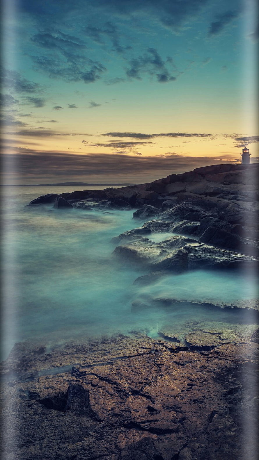 Long Exposure Coastal Scene with Lighthouse at Sunset Over Rocky Shore HD phone wallpaper