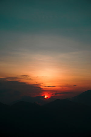 Sunset Over Mountain Silhouettes With Orange And Teal Sky HD phone wallpaper
