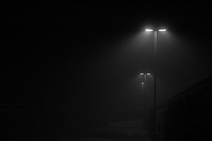 Atmospheric Black and White Street Lamps in Thick Fog at Night HD wallpaper