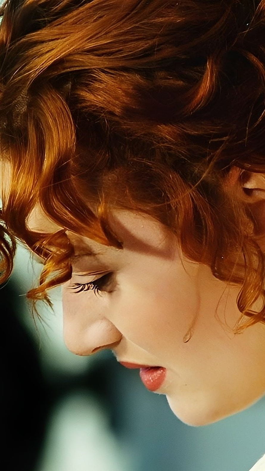 Kate Winslet Profile Portrait with Curly Red Hair and Soft Cinematic Lighting HD phone wallpaper