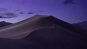 Purple Desert Dunes at Dusk with Distant Mountain Ranges Under a Twilight Sky HD wallpaper