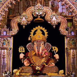 Ornate Golden Ganesha Idol in Temple Shrine with Trishul and Axe HD phone wallpaper