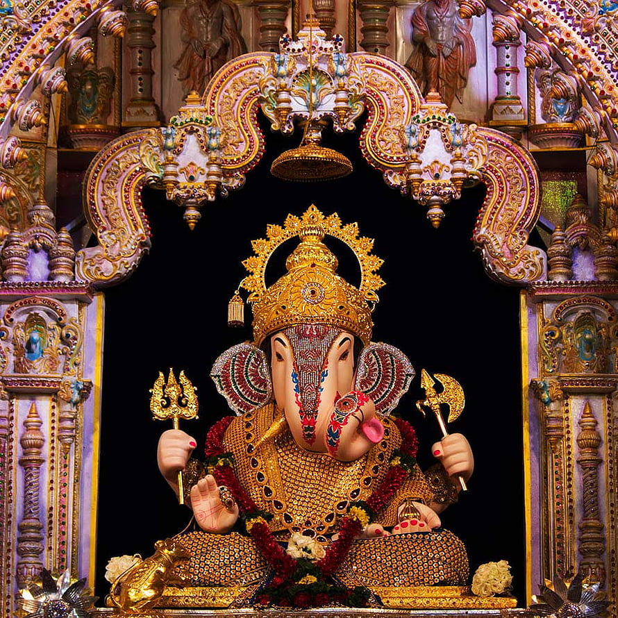 Ornate Golden Ganesha Idol in Temple Shrine with Trishul and Axe HD phone wallpaper