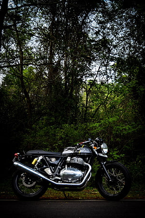 Royal Enfield Classic 350 motorcycle parked on a road surrounded by dense green forest trees HD phone wallpaper