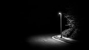 Lonely Street Lamp Illuminating a Dark Road at Night HD wallpaper